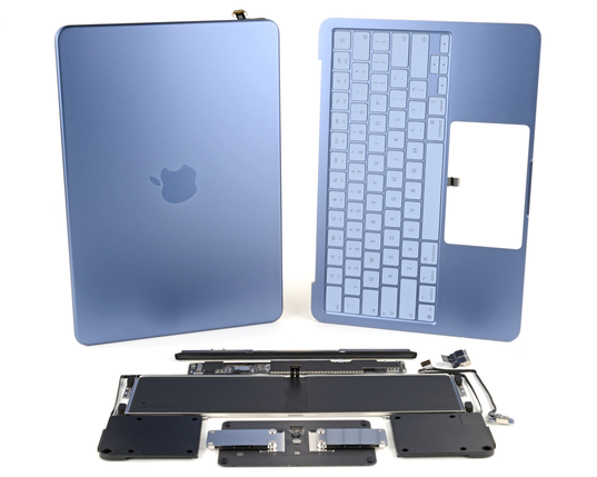 A MacBook’s blue aluminum outer shell and keyboard top case are shown above an organized layout of internal components, including the battery, trackpad assembly, and speakers, arranged neatly on a white background.