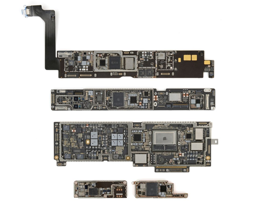 Several generations of Apple device logic boards are arranged in rows on a white background, showing how the internal motherboard designs have evolved and become more compact over time.